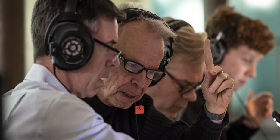 Recording technician and others review audio of a live performance.