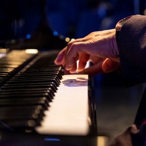 hands playing a piano