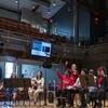 Performers and professor onstage