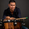 Man holding mallets over a timpani drum
