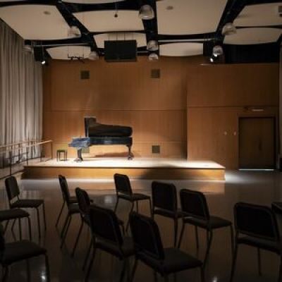 A piano on the stage of Klein Recital Hall.  