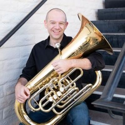Scott Sutherland holding a tuba.