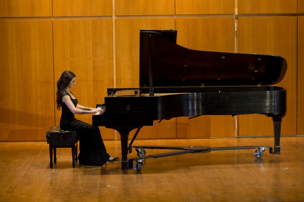 Woman playing piano in Rock Hall at Temple University