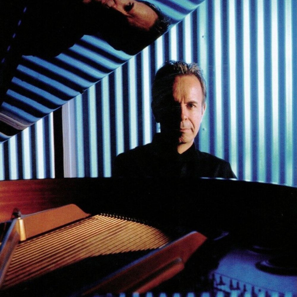 Man stilling with piano in foreground