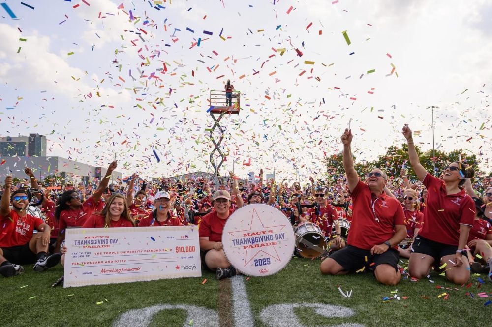 Photo of band members celebrating announcement of 2025 Macy's Thanksgiving Day parade