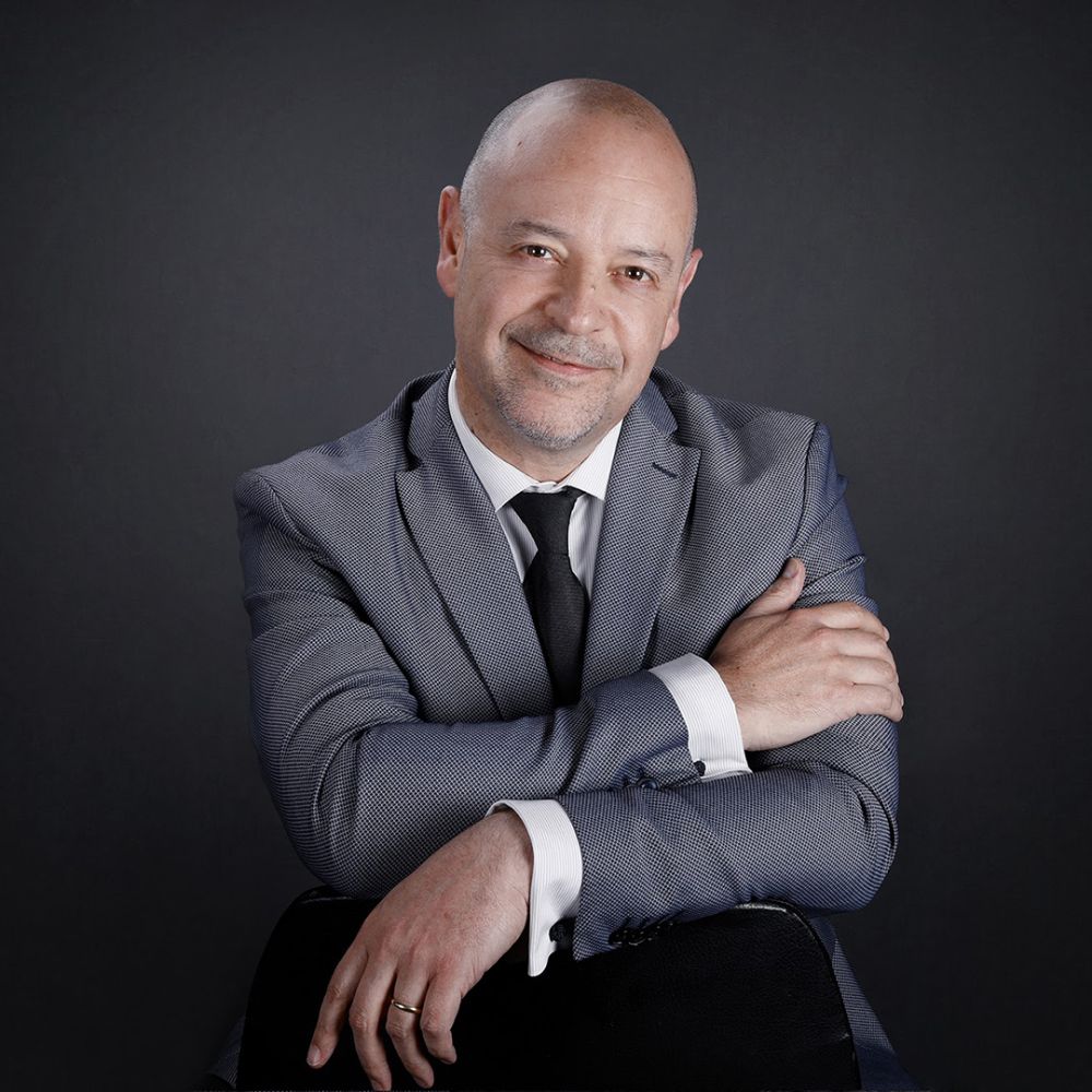 Man in grey suit on dark background