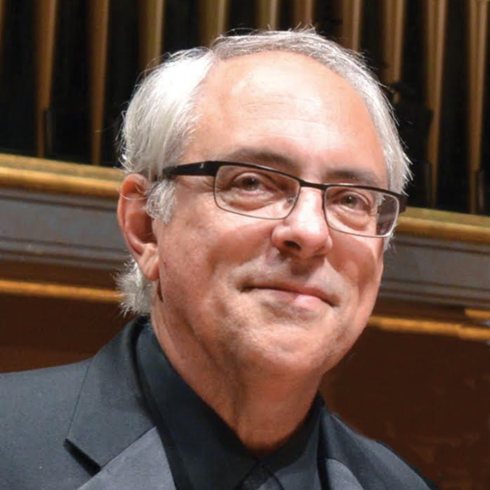 Photo of man wearing glasses and looking off camera
