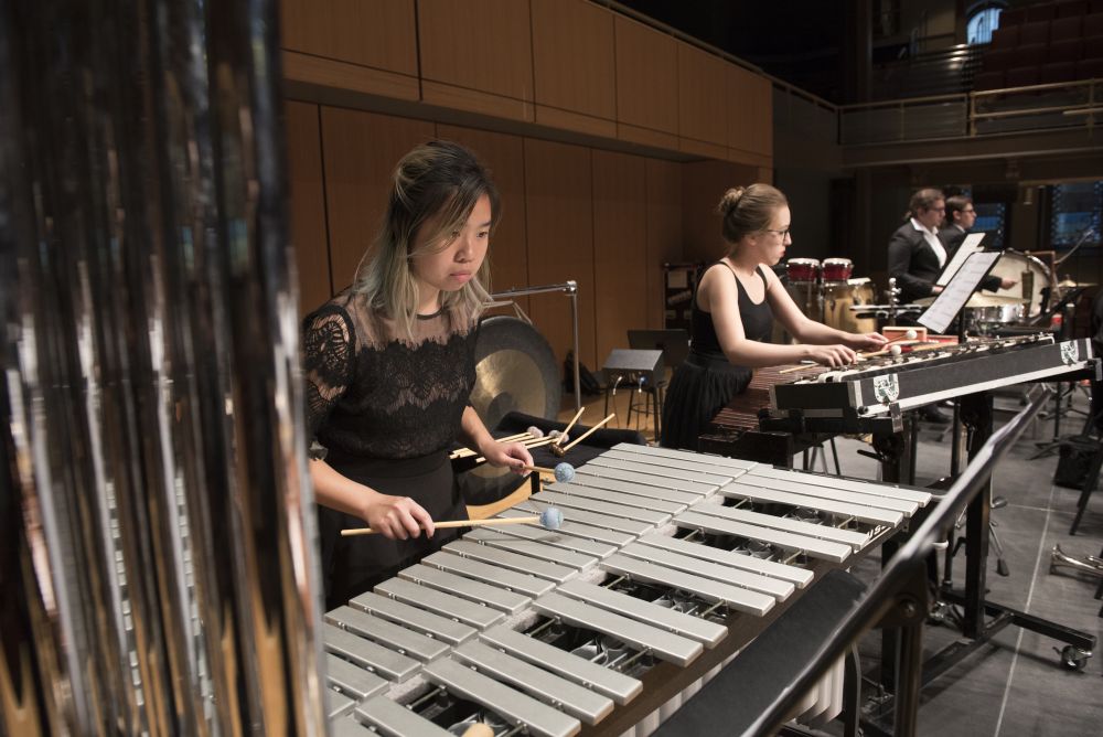Photo of Temple University Symphony Orchestra students playing various percussion instruments
