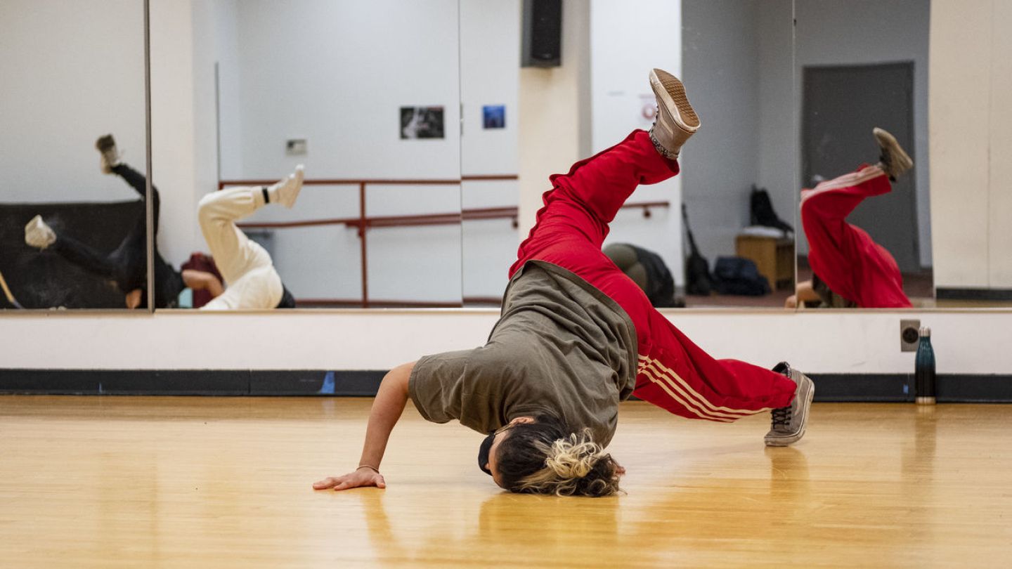 Image of a young person breakdancing in a dance studio
