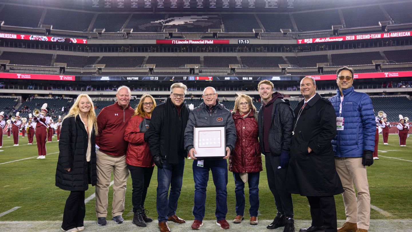 Photo of people standing on a football field