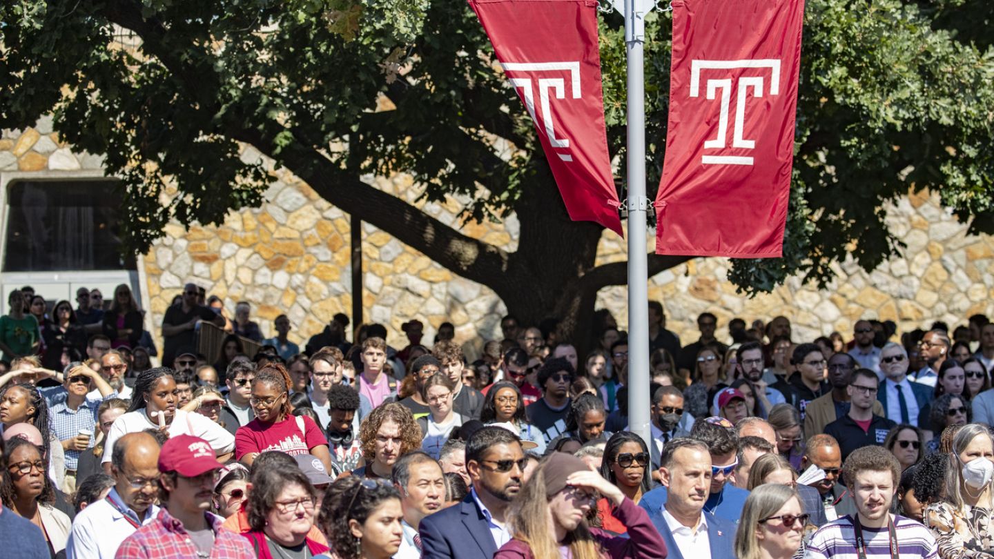 Image of Temple community members gathered around the Bell Tower