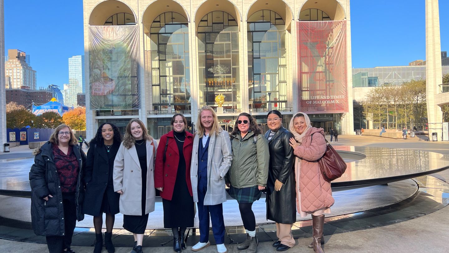 Photo of students and professor in front of the Met Opera in New York City