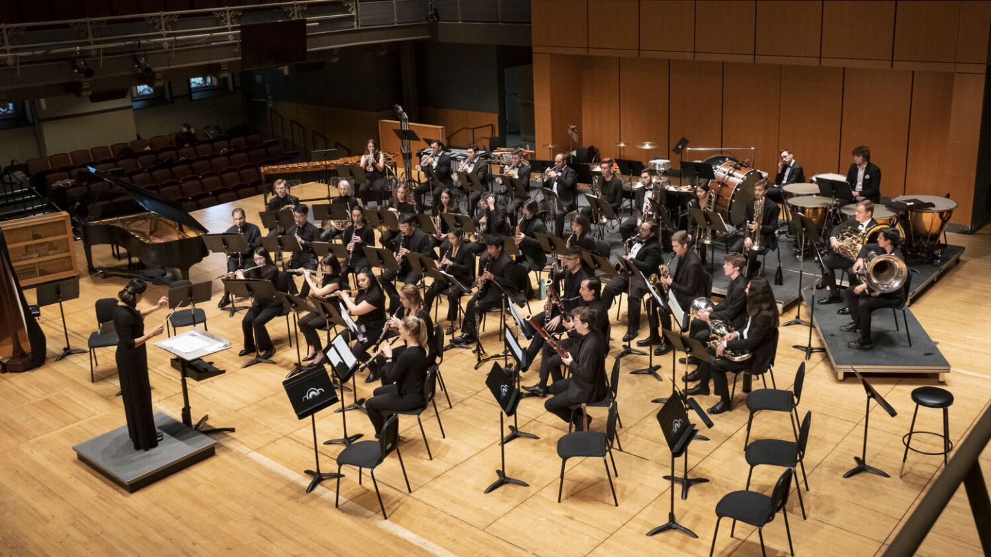 Photo of wind band rehearsing in a concert hall