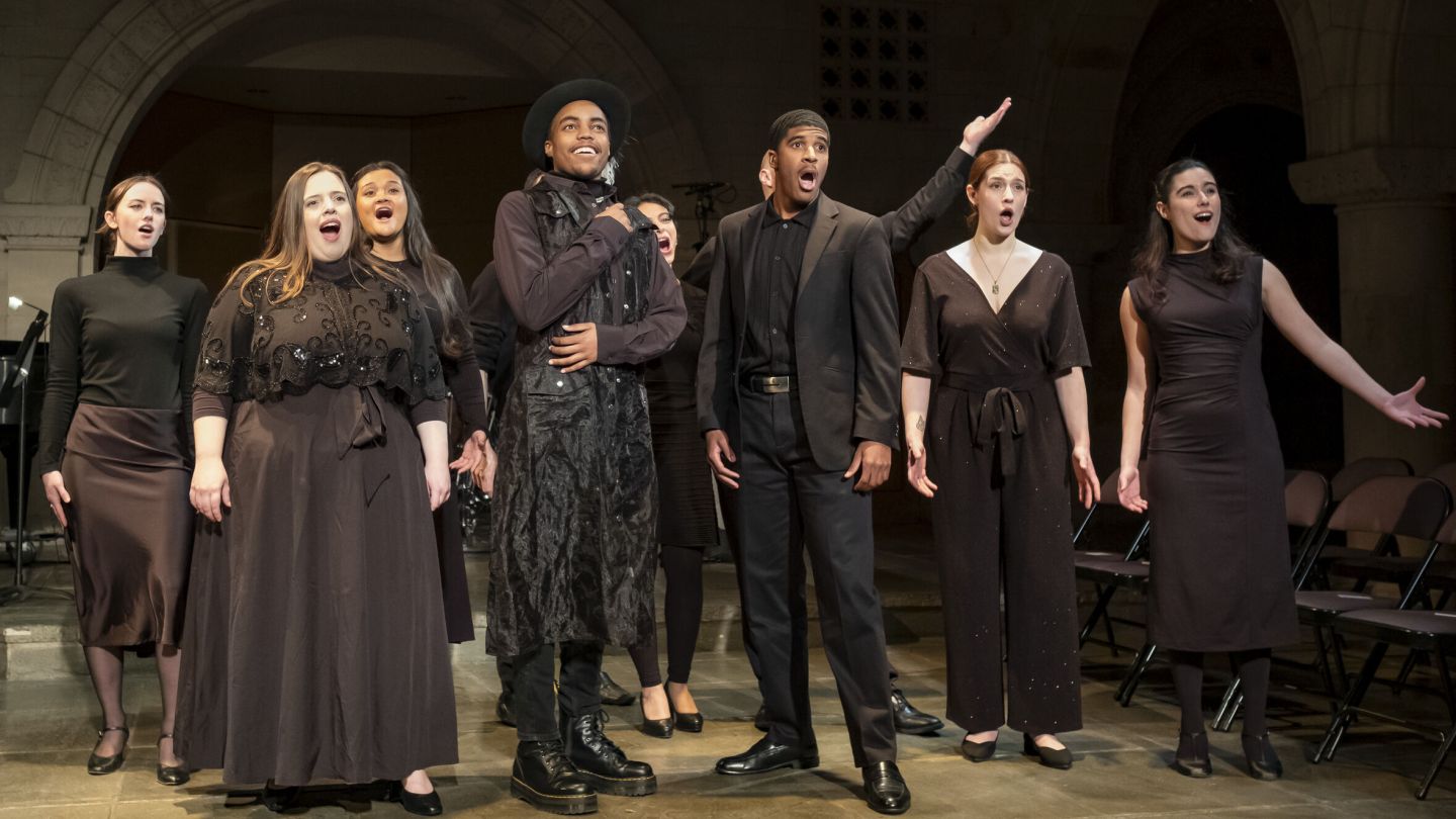 Photo of singers wearing all black, performing