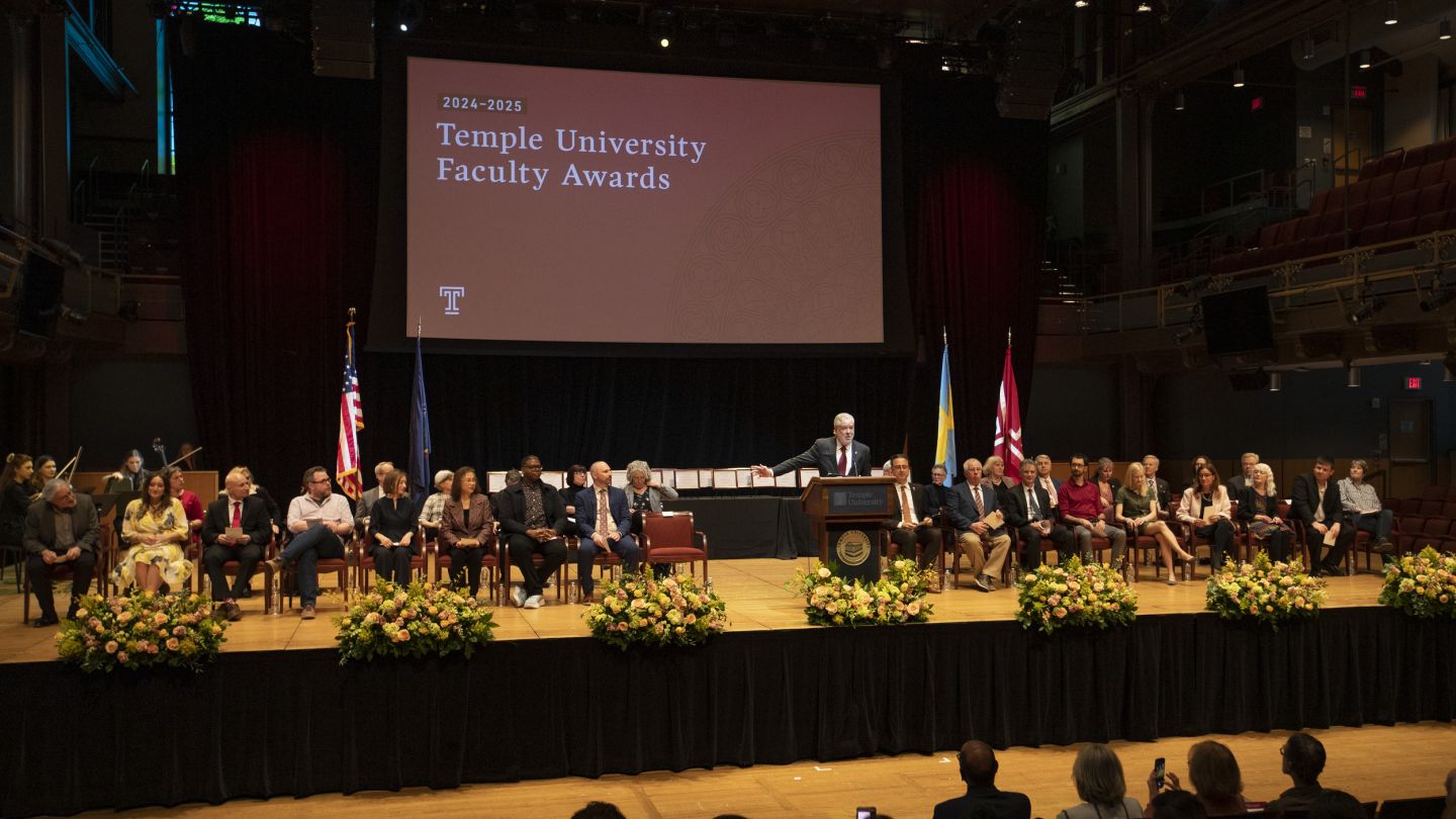 Photo of people sitting on a stage for an awards ceremony